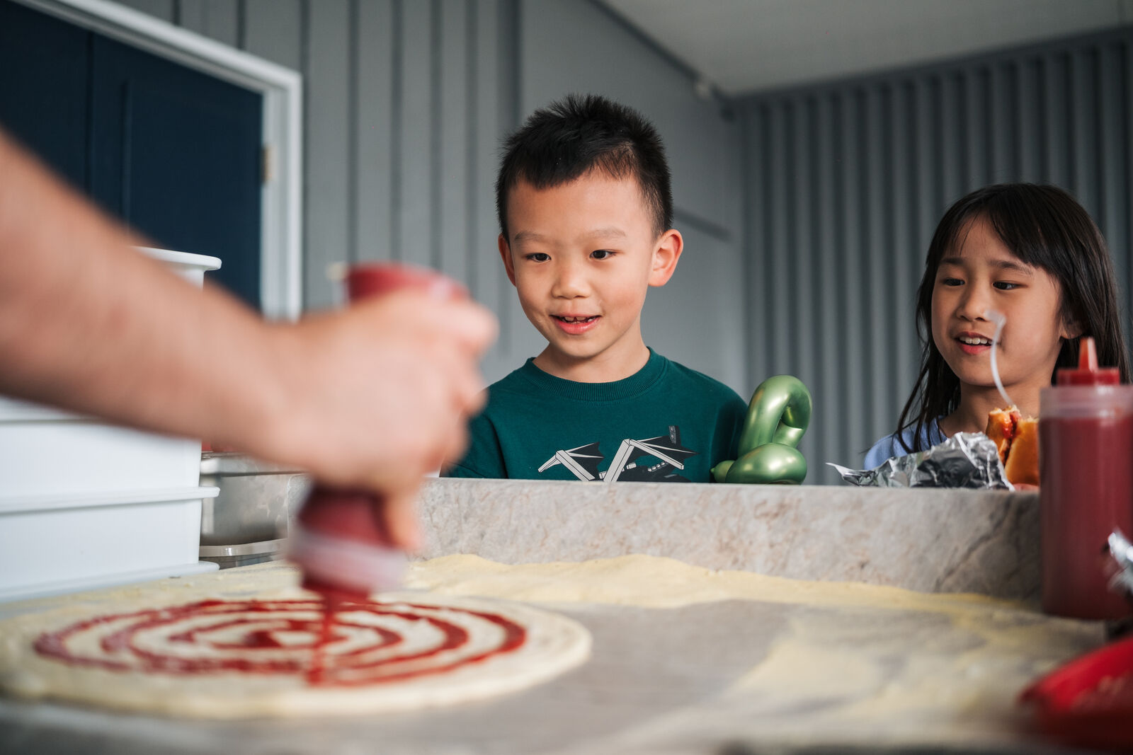 Fresh wood-fired pizza served at Ridgeview Elementary School Mayfair fair in West Vancouver by table one.