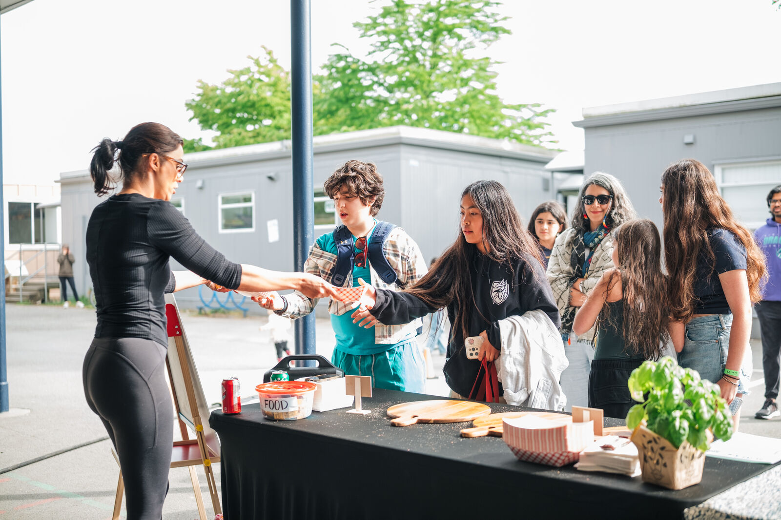 Families lining up at the table one. pizza station at Ridgeview Mayfair, West Vancouver