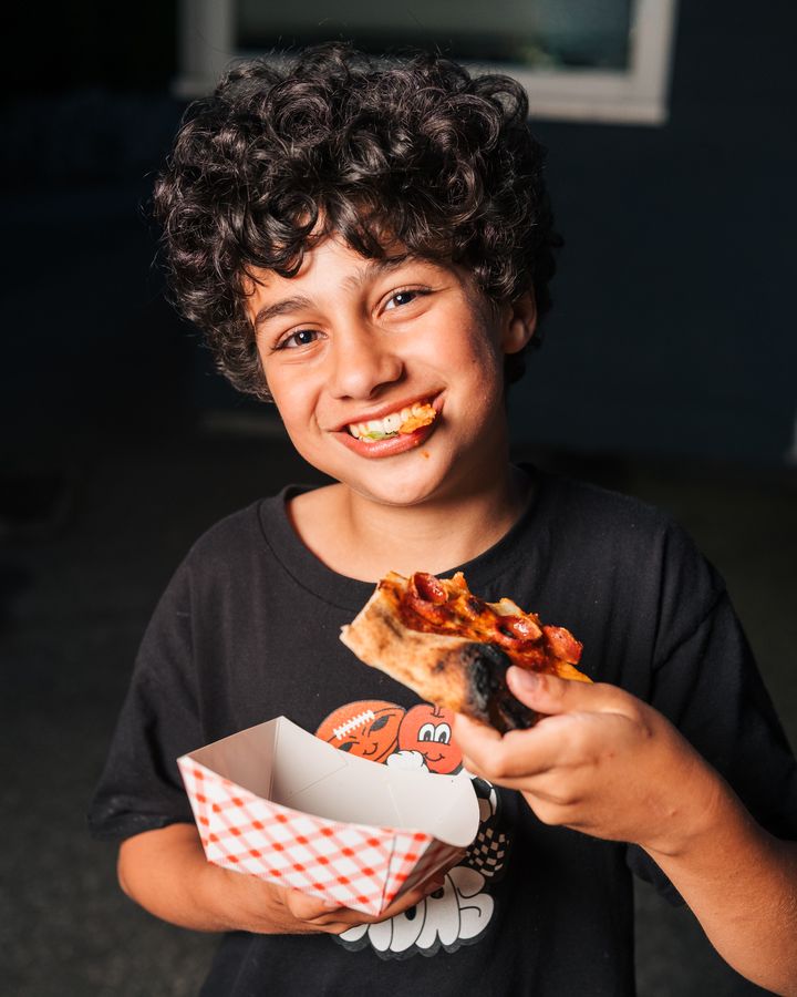 Young guest enjoying a slice