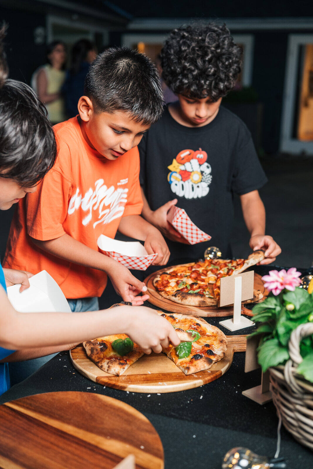 Kids enjoying pizza at a private birthday party catered by table one. in West Vancouver