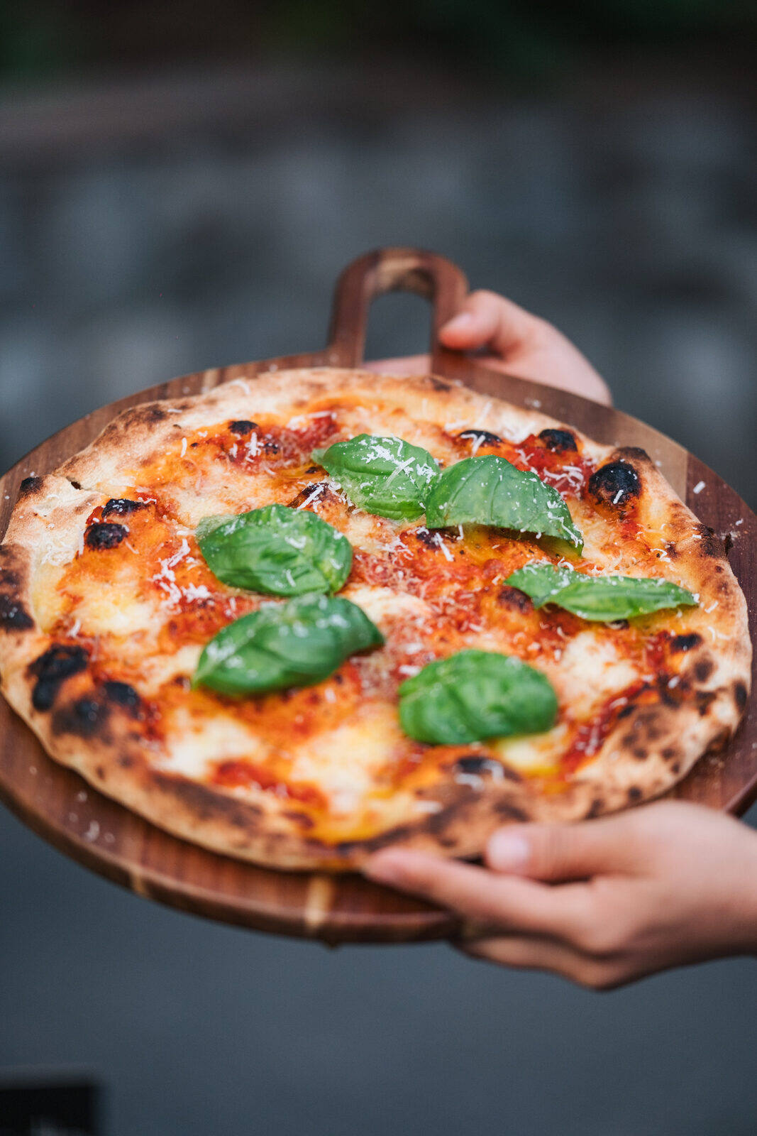 Guests gathering around the mobile pizza station at a private event in Vancouver