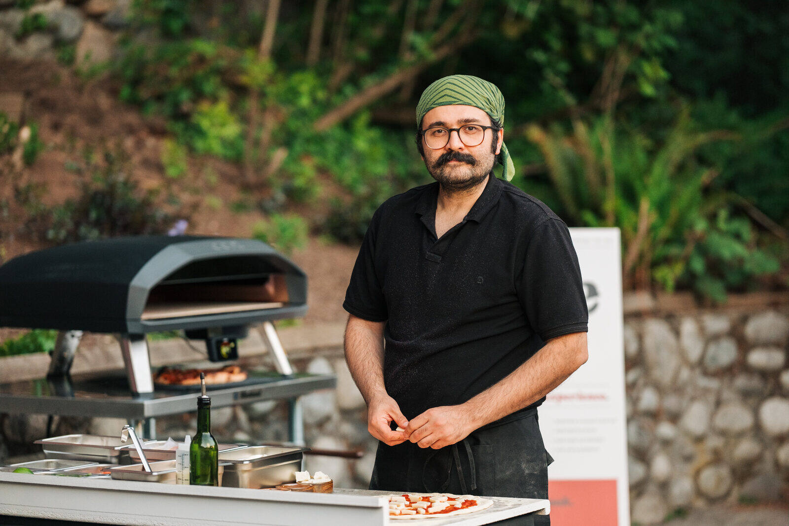 Pizza being sliced and served at a catered event in Metro Vancouver